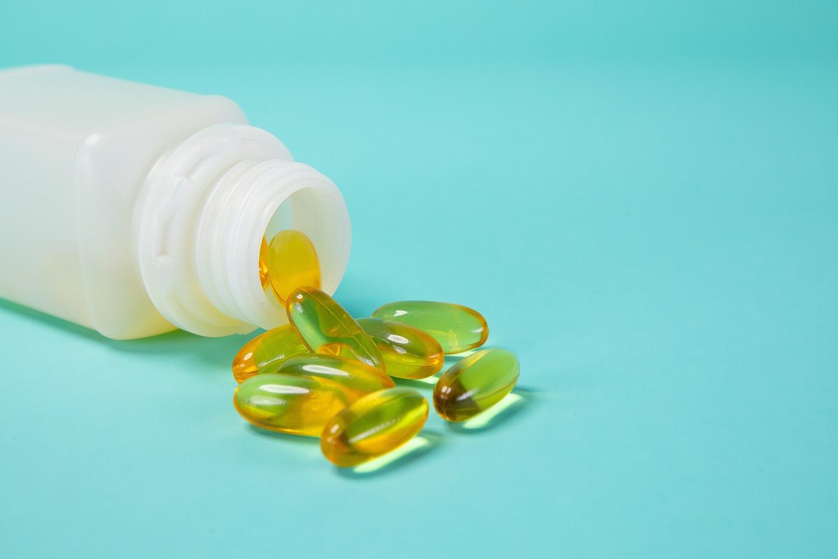 Capsules in a white supplement bottle