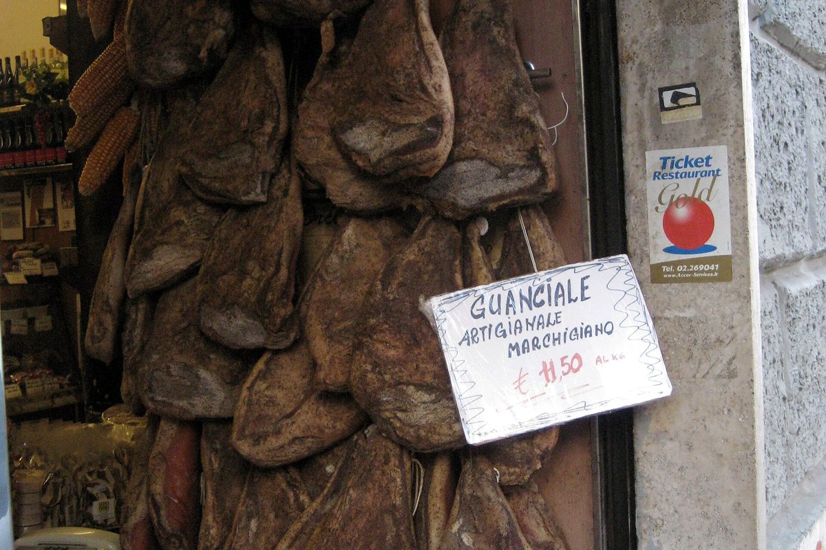 Guanciale, Italian dry-cured pork jowl, hanging in a curing room