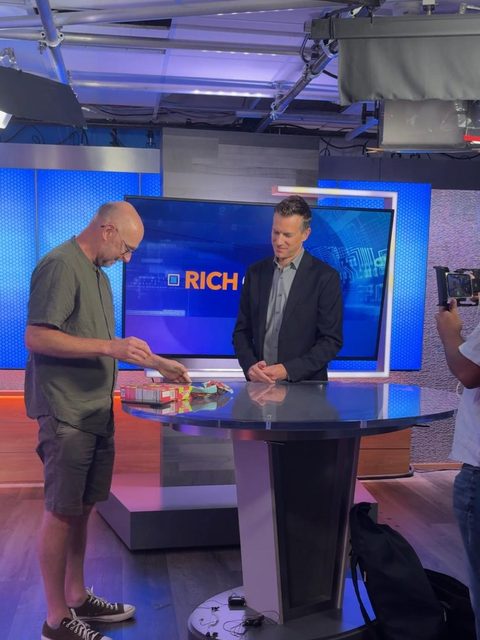 Numeline&rsquo;s founder showing a product to Rich DeMuro on set